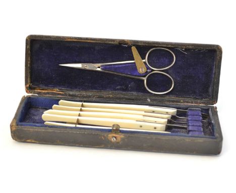 Eye surgeons scalpel set with scissors and five ivorine handled scalpels contained in fitted box, 19cm (6.5in) x 5cm (2in).Co
