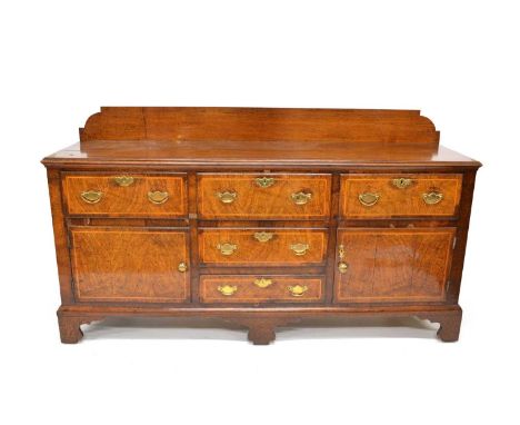 George III oak dresser base, three plank banded top with backboard base fitted with five drawers and two cupboards all veneer