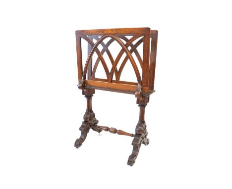 A Victorian walnut folio stand, two leaves with gothic moulded bars, each with brass hinges and ratchet mechanism, trestle ba