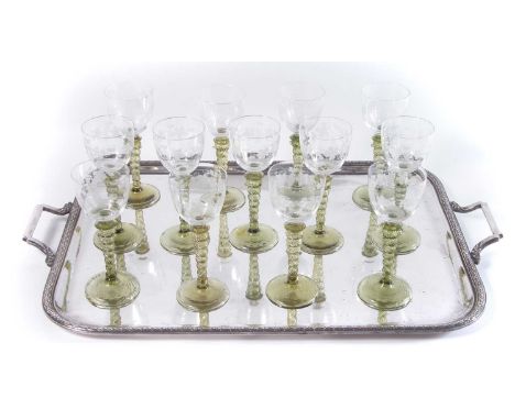 Thirteen Hock Glasses, with green twisted stems and engraved bowls, on plated tray, late 19th century.The glasses stand 18cm 