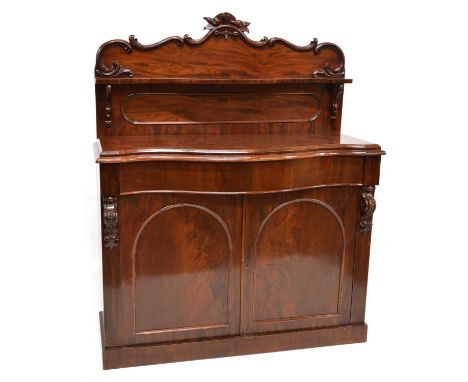 Victorian mahogany chiffonier, shaped back-board with molded and carved decoration, serpentine shelf with bracket supports mo