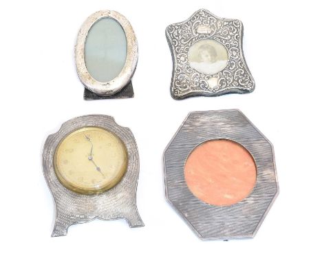 A selection of silver, to include a silver fronted dressing table clock, two silver fronted photo frames and one white metal 