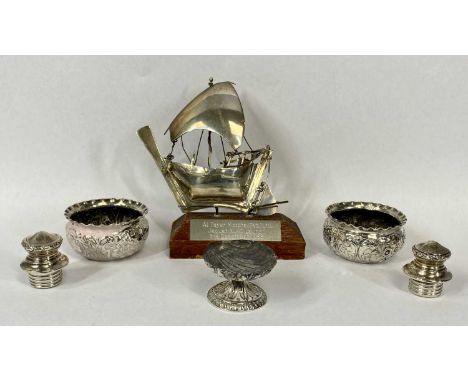 SILVER SALT TRIO, 2.3ozt, believed silver model of a small boat on wooden plinth and a pair of white metal stoppersProvenance