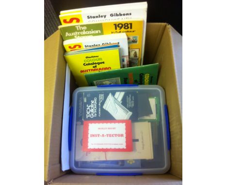 Box of Austrailian catalogues and other accessories, including mounts, guillotine, watermak detector, UV lamp etc