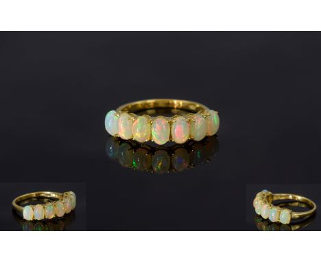 Opal Seven Stone Band Ring, a row of seven oval cut opal cabochons, curving across the finger, set in 14ct gold vermeil and s