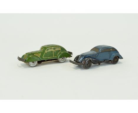 Vintage Tin Cars A pair of tin plate cars in, circa 1930's. The first in cadet blue with tin bumpers and wheel arches. The se