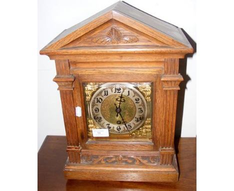 An oak cased chiming mantel clock - 42cm high 