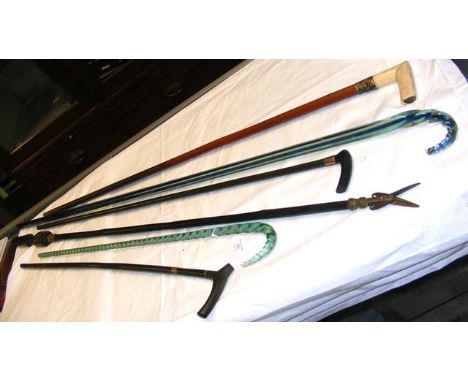 Glass walking stick, together with others and a pair of antique pruners 