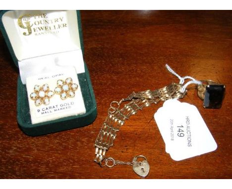 A gold bracelet, earrings and ring 