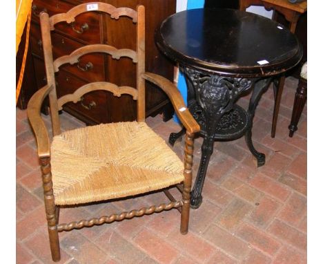 Cast iron pub table, together with a ladder back chair 