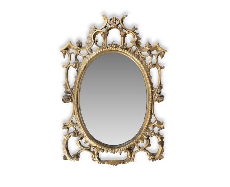AN IRISH GEORGE III CARVED GILTWOOD OVAL WALL MIRROR, the gadroon frame within an open trellis of scrolls and flowerheads, su