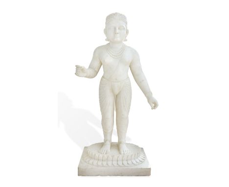 AN INDIAN WHITE MARBLE FIGURE OF A STANDING DEITY, VAMANA  (18th/19th Century), balanced on a double lotus base,  wearing a l