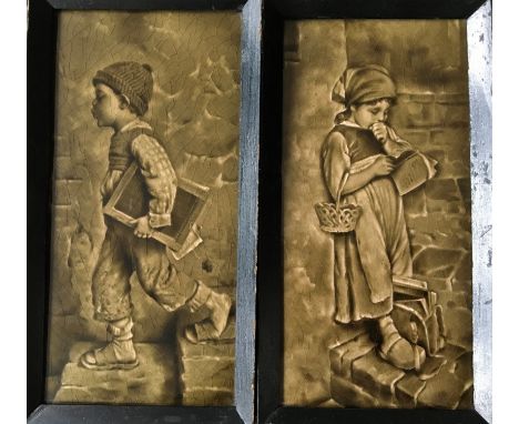 Framed ceramic glazed tiles depicting young boy and girl, 29.5cm x 14cm. IMPORTANT: Online viewing and bidding only. No in pe