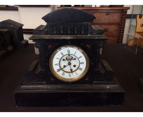 A black slate classical temple design mantel clock with red marble inlay and engraved detail, height 43.5cm.&nbsp;IMPORTANT: 