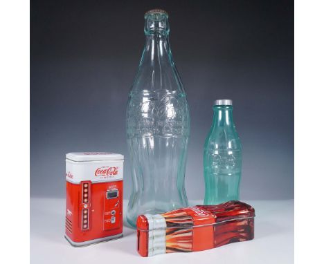 This 4-piece Coca-Cola themed collection includes two tin coin banks and two bottle banks, one made of glass and the other pl