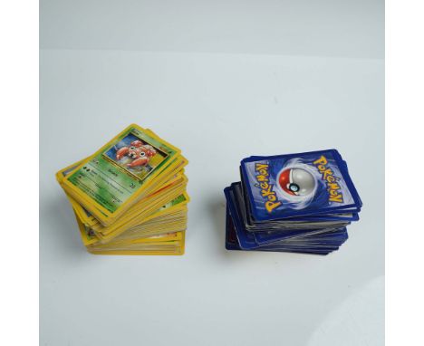 Assortment of over 100 Pokemon trading cards featuring a variety of characters, including both vintage and modern examples. C