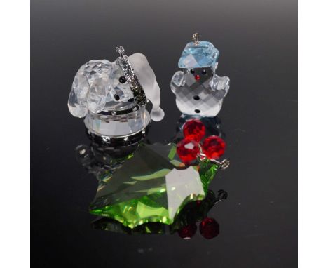 Set of three Swarovski crystal ornaments, each marked with the Swarovski swan. The group includes: a clear crystal Kris Bear 