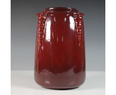 A striking Roseville Pottery vase from the Topeo line. This piece is finished in a rich red high-gloss glaze, characteristic 