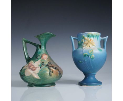 Pair of vintage Roseville Pottery vases. The first vase is a green pitcher-form vase in the Magnolia pattern, shape number 13
