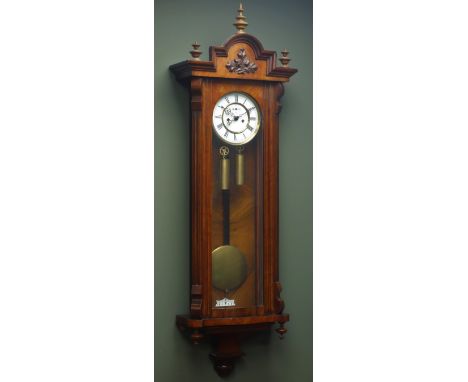 Late 19th century figured walnut Vienna wall clock, stepped arch pediment with turned finials, white enamel dial with subsidi