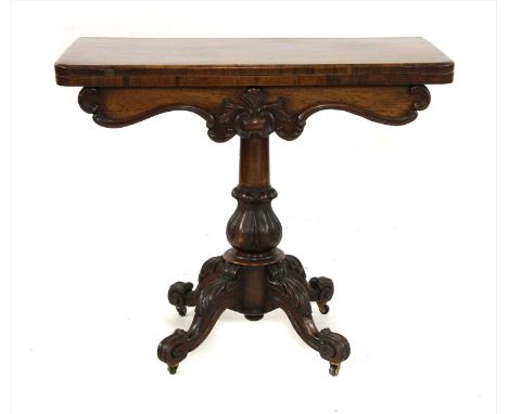 A William IV rosewood card table, having foldover rectangular top above central carved tulip column, descending onto four aca