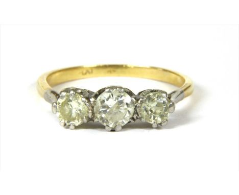 A gold three stone diamond ring, a brilliant cut diamond with a smaller brilliant cut diamond at each side, estimated as appr