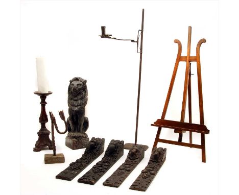 A carved softwood pricket candlestick, 31cm high, a carved pine seated lion, 40cm high, four carved wood brackets, etc  Prove