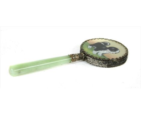 An oriental mirror, the back painted with a dog on a jade handle
