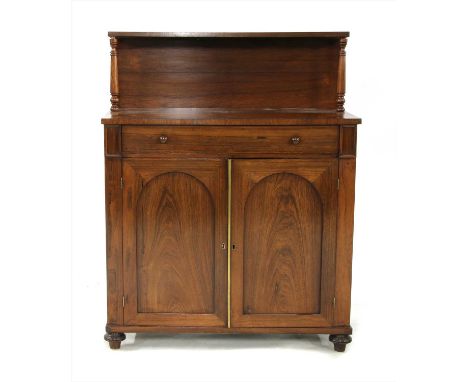 A rosewood chiffonier, with a single shelf over a drawer and a central cupboard, 91.5cm wide x 44cm deep x 116cm high, From t