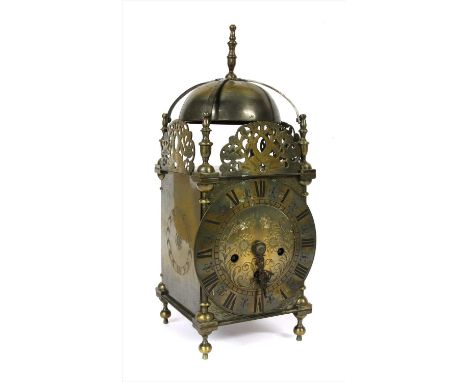 A 17th century style brass eight day lantern clock, the chapter ring set with Roman numerals, the movement chiming on a coil,