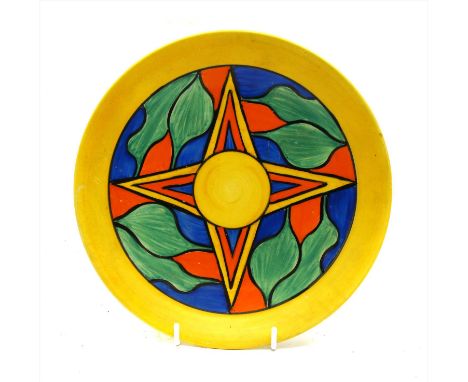 A Clarice Cliff Bizarre pattern plate, the yellow stand with star centre within a stylised foliage border in green, orange an