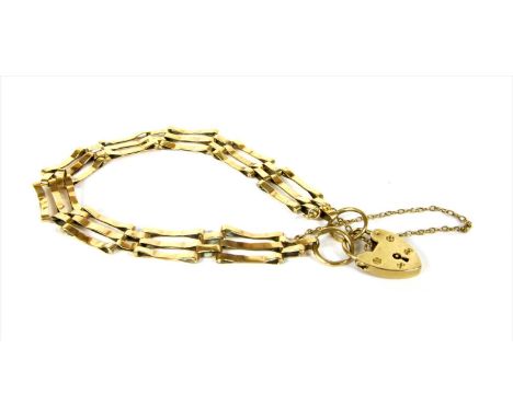 A 9ct gold three row gate bracelet, plain bars with crimped centres, to heart shaped padlock clasp and safety chain, London 1