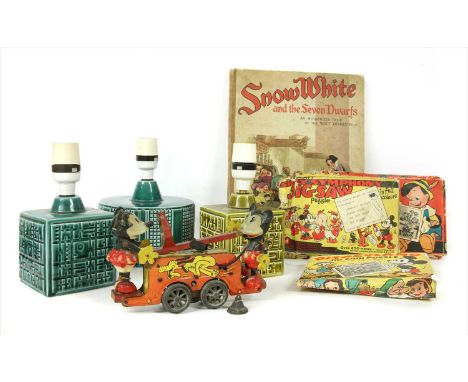 A Mickey and Minnie Mouse clockwork tinplate hand cart, c.1935 , with repairs and losses, 18cm long, three Disney jigsaw puzz