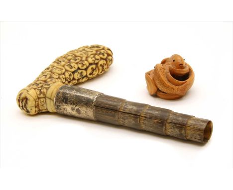 A Japanese carved ivory walking stick handle , made up of multiple faces, signed, and a carved wooden double carp netsuke, si