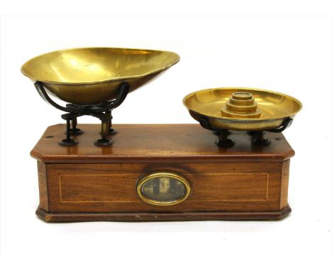 A set of brass weighing scales , together with weights, 1oz, 2oz, 4oz and 8oz
