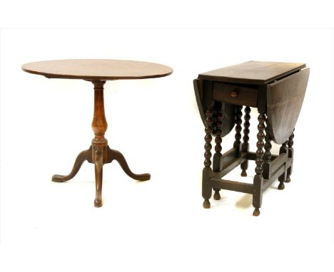 An oak drop leaf table, 17th century and later, the oval top on bobbin turned supports, 109cm wide, 87cm deep, 73cm high, and