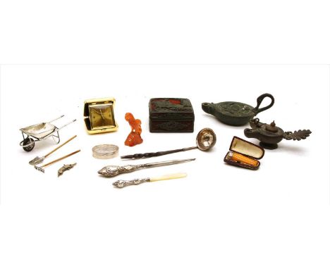 A miniature silver plated wheelbarrow, rake and spade, a reproduction Roman oil lamp, a George III silver ladle with a whaleb