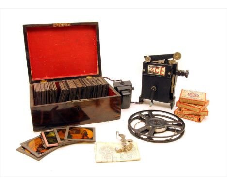 A collection of cased 19th century coloured glass lantern slides , together with a miniature projector