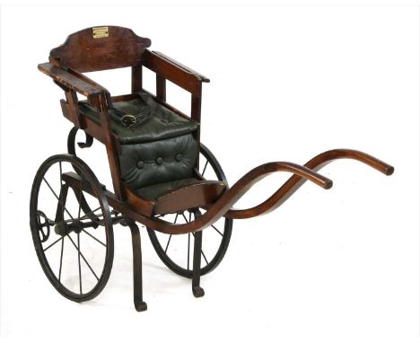 A 19th century stained pine and mahogany doll's mail cart, with padded seat and spoked metal wheels, with label for H. Staffo
