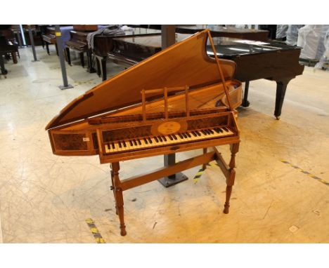 Spinet by Alan Whear.  A wing spinet in a walnut case with burr walnut panels on a trestle base, with a 5-octave compass. Thi
