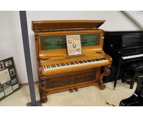 Brinsmead (c1855) An upright piano in a birch case with carved keyboard supports and an ornate fretwork front panel; together