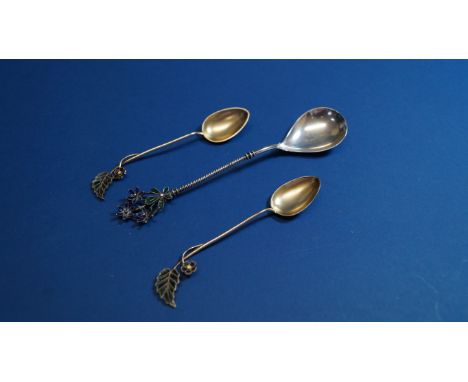 A pair of Scandinavian .900 silver gilt and plique a jour enamel spoons, by Marius Hammer, having floral terminals, 10cm; and