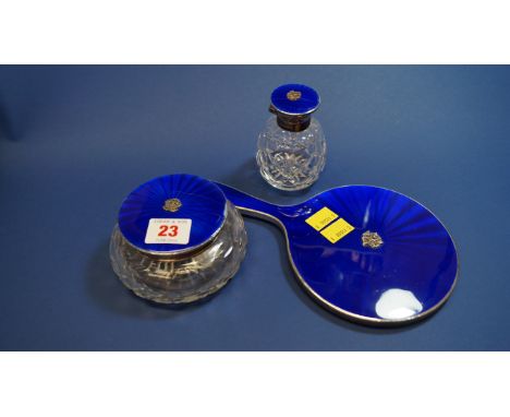 A silver and blue enamel hand mirror; and two matching dressing table containers, by Henry Clifford Davis, Birmingham 1949. C
