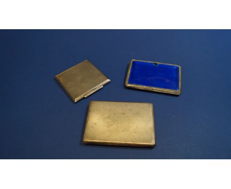 A .935 silver and blue enamel compact; together with a Continental .800 engine turned cigarette case; and another compact.