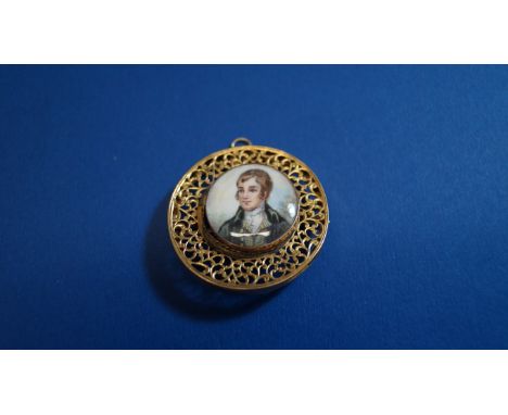 An antique portrait miniature of a gentleman, on ivory, in 9ct gold frame, inset into a pierced yellow metal brooch mount.