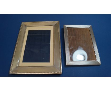 A .925 sterling silver rectangular engine turned photograph frame, 15 x 10cm; and another white metal frame 19 x 15cm.