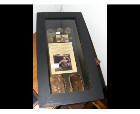 A cased display containing 'German stick grenade parts recovered from the Somme battlefield'  