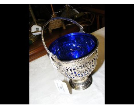 A decorative silver pierced bowl with swing handle and blue glass liner - having London hallmark - 1912 - 7.5oz 