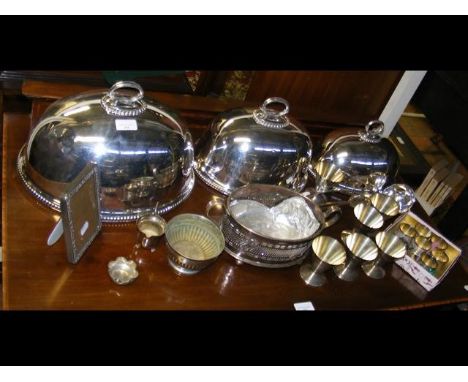 A graduated set of three silver plated meat covers, etc. 