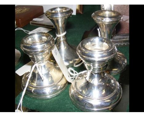 A pair of silver candlesticks, together with one other pair CONDITION REPORTCandlesticks have dents